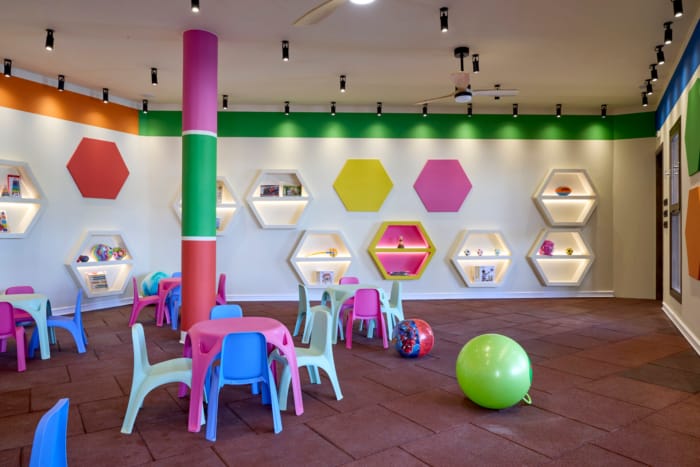 a room with a few chairs and a table with a balloon